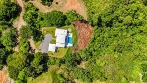 Aerial view of a luxury home surrounded by lush greenery in Dominical, Costa Rica.