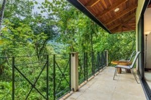 Balcony of tropical villa with lush jungle view in Dominical, Costa Rica.