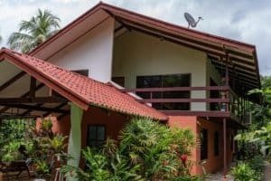 Costa Rica real estate property with house, cabin, and lush tropical garden.