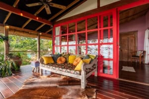 Cozy living room with colorful cushions and ocean view in Dominical, Costa Rica.
