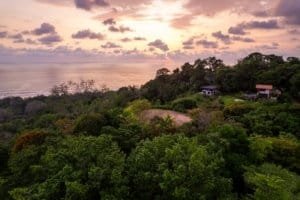 Scenic view of lush greenery and ocean at sunset in Dominical, Costa Rica.