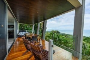 Balcony with seating overlooking lush jungle and ocean in Dominical, Costa Rica.