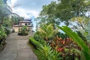 Elegant Mediterranean-inspired villa surrounded by lush tropical garden in Dominical.