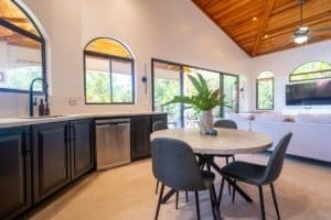 Interior of modern jungle home with open kitchen and living area in Dominical.