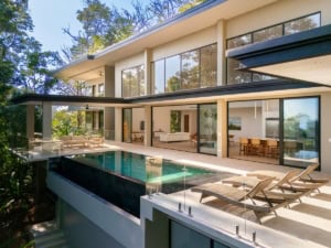 Modern tropical home with ocean view, infinity pool, and outdoor lounge.