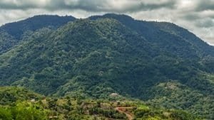 Lush green mountains with cloudy sky in Dominical, Costa Rica.