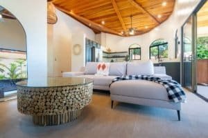 Spacious living room with high wooden ceiling and tropical decor in Dominical.