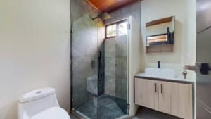 Contemporary bathroom with walk-in shower and vanity in Dominical.