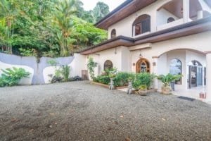 Luxury Costa Rican villa with lush tropical surroundings and driveway.
