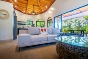 Bright living room with large windows and tropical views in Dominical.