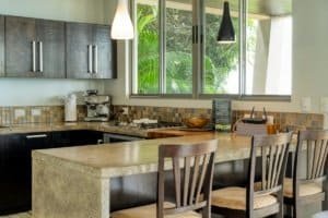 Contemporary kitchen with granite island and tropical view in Dominical.
