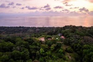 Aerial view of lush greenery and ocean in Dominical, Costa Rica.