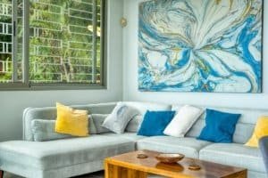 Bright living room with colorful cushions and abstract wall art in Costa Rica.