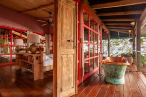 Rustic Costa Rican home with wooden floors and ocean view balcony.