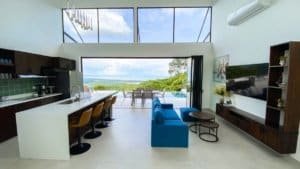 Modern living room with panoramic ocean and mountain views in Dominical.