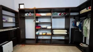 Large walk-in closet with shelves, clothes, and storage in Costa Rica.