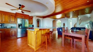 Open-concept kitchen and dining space with wooden accents and ocean view.