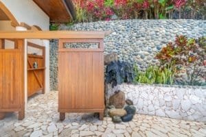 Beautiful garden with pebble wall, plants, and stone pathway in Dominical.