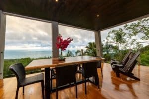 Covered outdoor dining area with ocean view and lush greenery in Dominical.