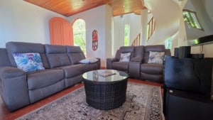 Interior view of a living room with leather sofas and wooden ceiling in Dominical.