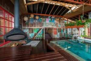 Indoor pool with colorful wall art and cozy seating area in Costa Rica.