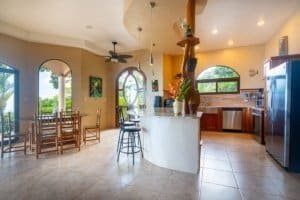 Bright open kitchen with dining space and tropical decor in Dominical.