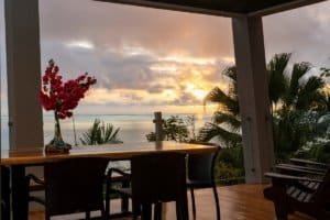 Modern jungle home with ocean view, sunset, and tropical plants in Costa Rica.