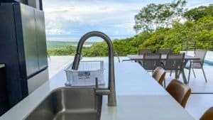 Modern outdoor kitchen with panoramic ocean and mountain scenery in Dominical.