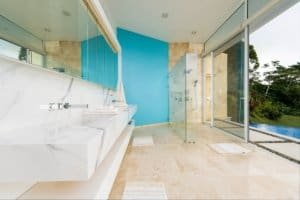 Modern bathroom with glass shower and ocean view in Costa Rica.