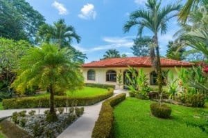 Beautiful tropical jungle home with lush garden and palm trees in Dominical.