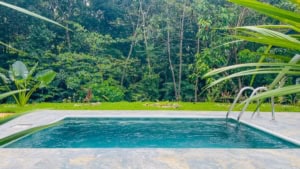 Swimming pool with lush jungle background in Dominical, Costa Rica.