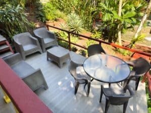 Relaxing outdoor terrace with chairs, table, and tropical plants in Dominical.