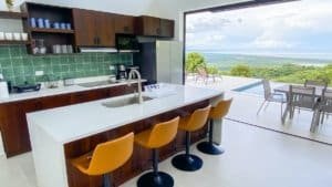 Modern kitchen with panoramic ocean and mountain views in Dominical.