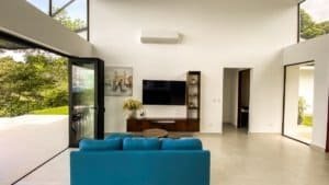 Bright living room with large glass doors and mountain views in Dominical.