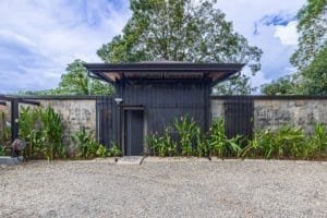 Contemporary house with lush greenery and gravel driveway in Dominical, Costa Rica.