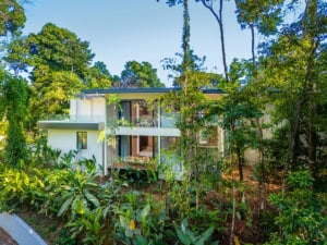 Modern tropical house surrounded by lush greenery in Dominical, Costa Rica.