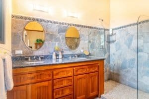 Elegant bathroom with dual sinks, mirrors, and walk-in shower in Costa Rica.