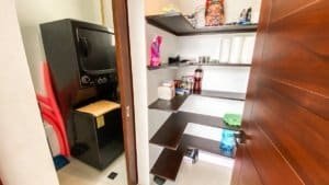 Interior view of a pantry with shelves and various stored items in Dominical.