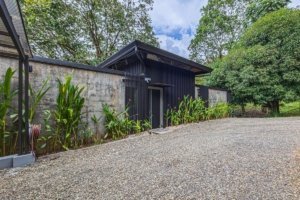 Contemporary house with black exterior and lush greenery in Dominical.