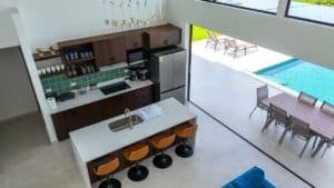 Contemporary kitchen with island, pool, and outdoor dining in Dominical.