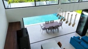 Modern living room with pool, mountain view, and stylish decor in Dominical.
