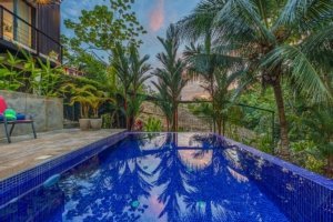 Beautiful tropical pool with lush greenery in Dominical Costa Rica.