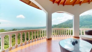 Beautiful balcony of a Spanish colonial home overlooking mountains and ocean.