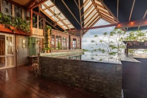 Elevated ocean view deck with lush greenery and modern architecture.