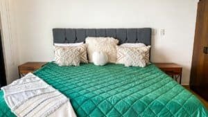 Comfortable bedroom with a large bed, decorative pillows, and ocean view.