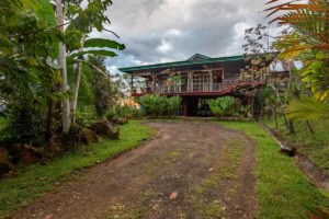 Elevated ocean view home surrounded by lush tropical greenery in Dominical.