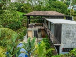 Modern house with pool and lush tropical garden in Dominical, Costa Rica.