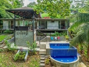 Luxury home with pool in Dominical, Costa Rica, surrounded by lush greenery.