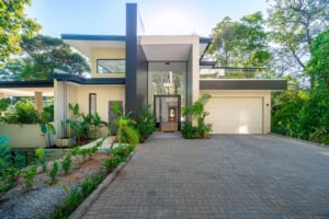 Contemporary tropical house with lush garden and driveway in Dominical.