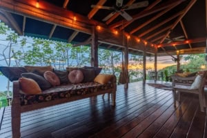 Relaxing porch with ocean view, cozy seating, and sunset scenery in Dominical.